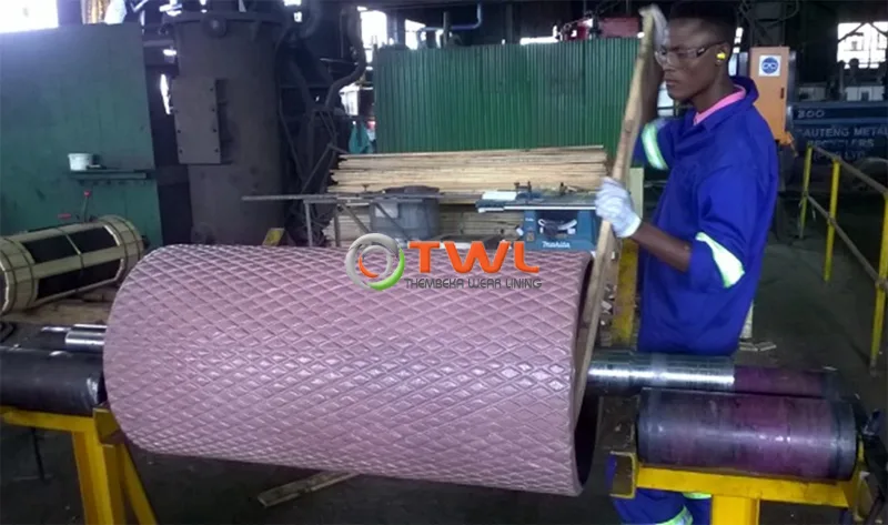 TWL technician applying a textured wear compound to a pulley